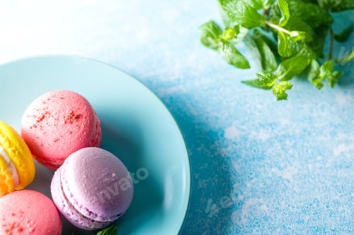 Preview: Colored macaroons. Delicious sweet colorful French desserts on light background