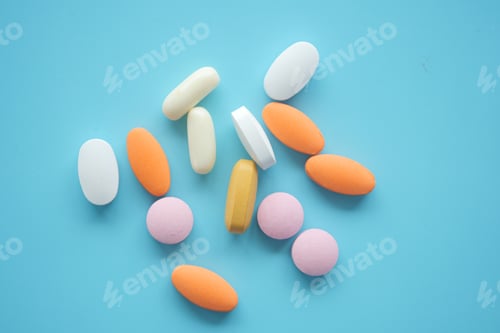 Preview: A Vibrant and Colorful Assortment of Various Pills Arranged on a Blue Background