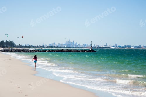 Preview: A girl running on the beach with City view