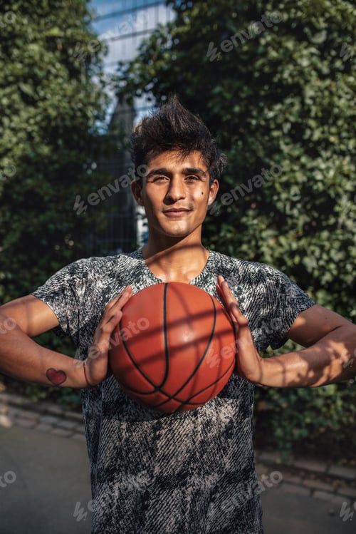 Preview: Young basketball player holding a ball