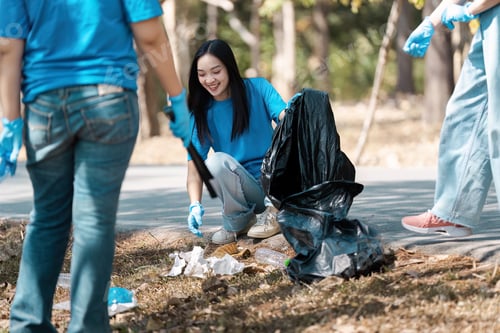 Preview: Group of Volunteers Cleaning Up Park Litter and Trash on a Sunny Day for Environmental Conservation