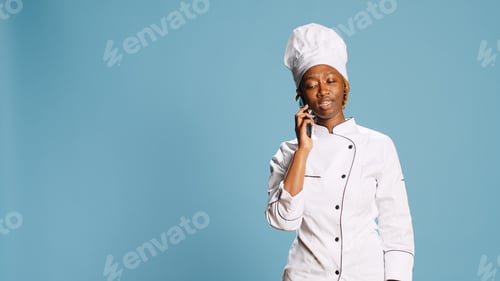 Preview: Professional chef talking on phone call in studio