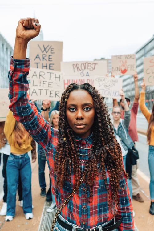Preview: portrait of african american young woman with raised fist