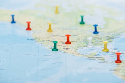 Preview: selective focus of colorful push pins on world map with copy space