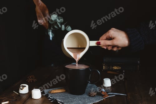 Preview: Pouring Hot Chocolate into Mug on Wood Table