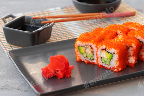Preview: California sushi roll served on black ceramic plate