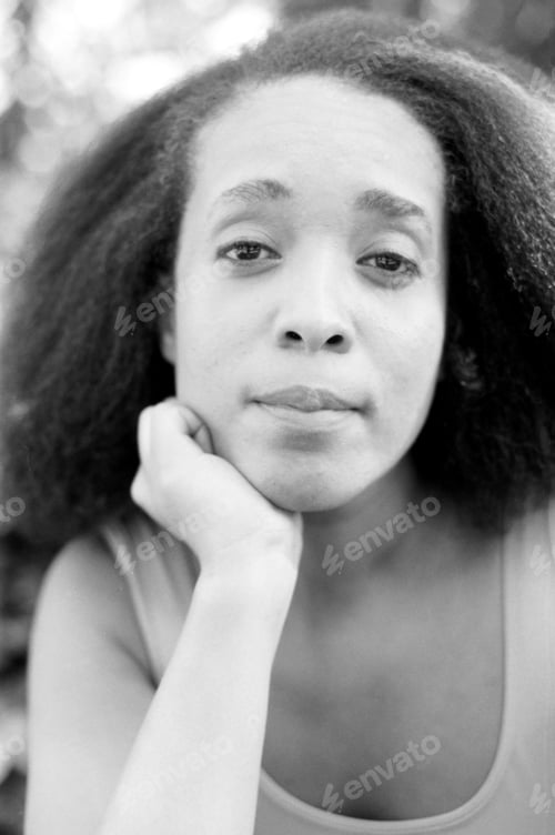 Preview: Pensive woman resting chin on hand in monochrome portrait