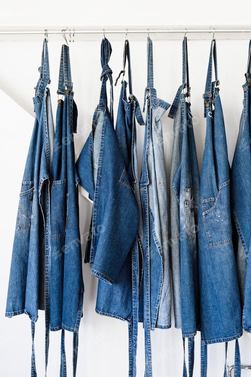 Preview: Denim aprons hanging in a row