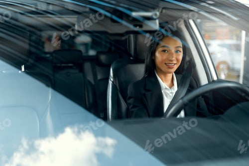 Preview: Woman sitting in a car