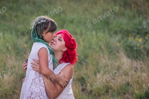Preview: Bright, diversity, extraordinary mother daughter hugging in forest. Woman has pink hair, girl green