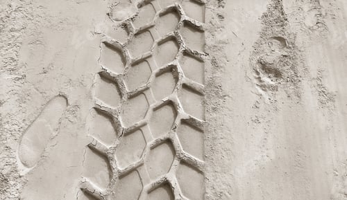 Preview: Wheel track and footprints on the sand
