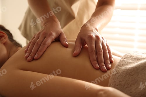 Preview: Young woman receiving back massage in spa salon, closeup