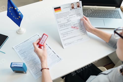 Preview: Consular Officer Making Decision At Table