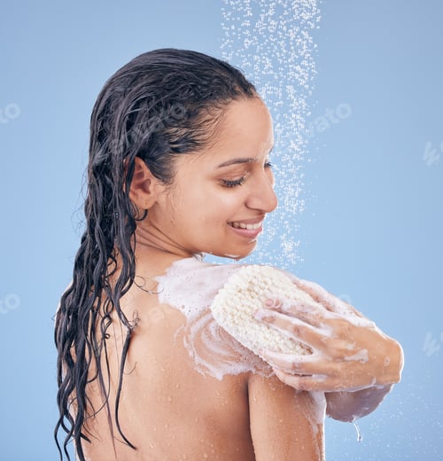 Preview: Getting fresh for the day. Shot of a young woman using a sponge while taking a shower.
