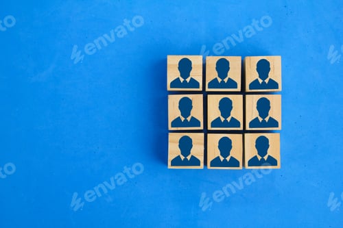Preview: wooden cube and worker icon in square arrangement. The concept of human resources.