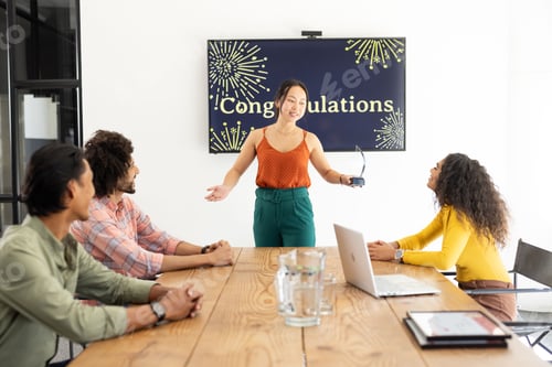 Preview: Presenting in meeting room, businesswoman engaging with colleagues at conference table