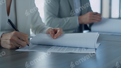 Preview: Woman hand holding papers closeup. Managers signing corporate deal with investor
