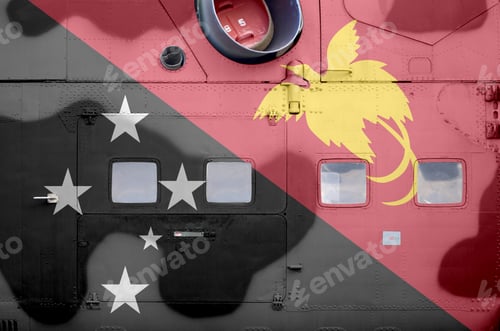 Preview: Papua New Guinea flag depicted on side part of military armored helicopter close up