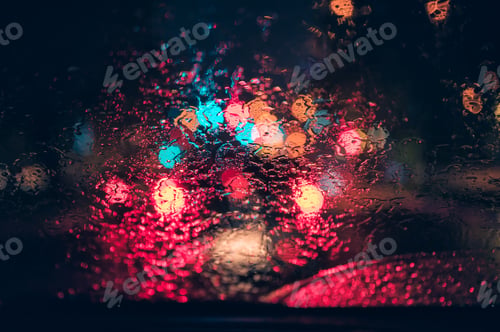 Preview: Abstract colorful bokeh raindrop on windshield in rainy day at night