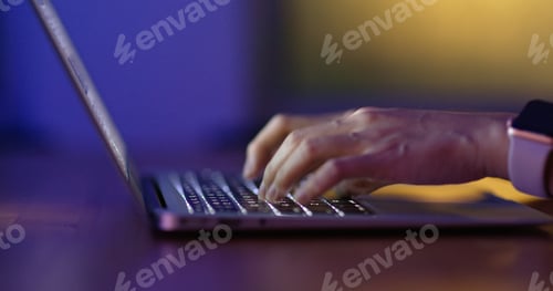 Preview: Type on laptop computer at night