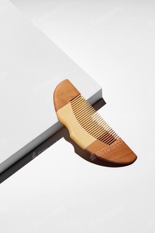 Preview: Wooden hair comb Isolated on a white podium with black shadow. Trendy catalogue shot with copy space