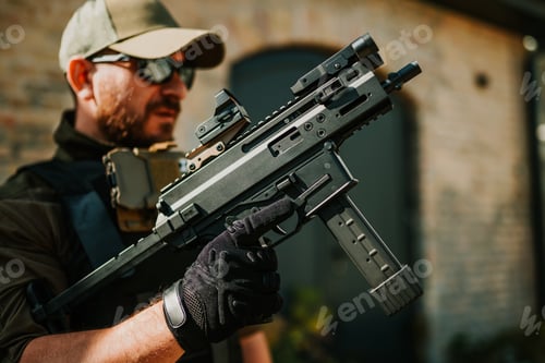 Preview: Soldier holding a modern submachine gun with red dot sight and tactical gloves