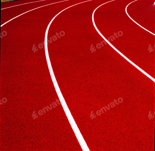 Preview: View of a red running track with white lines captured on a sunny day