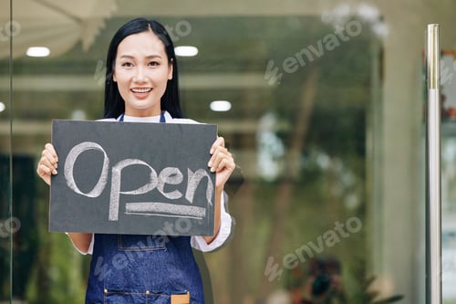 Preview: Cafe owner showing open sign