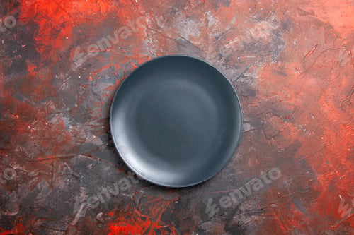 Preview: Close up view of empty black plate on black background