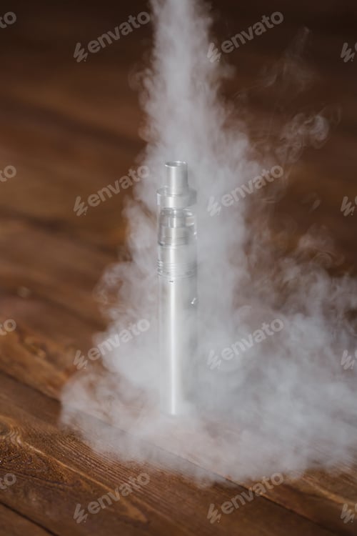 Preview: Electronic cigarette on a wooden table. Smoke