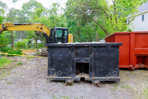 Preview: Industrial dumpster filled loaded rubbish removal container renovation building on house under