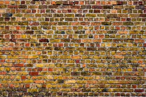 Old brick wall with orange and yellow bricks