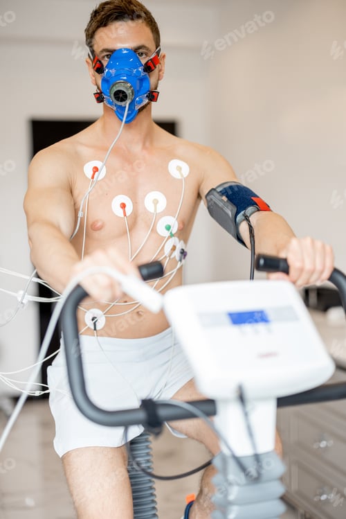 Preview: Man examining his cardiovascular system on bike simulator