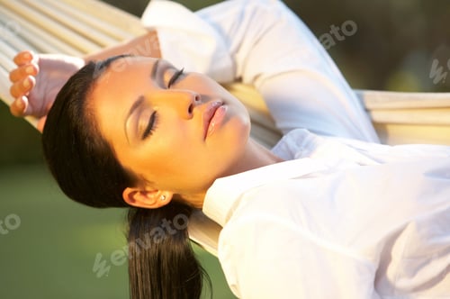 Preview: Serene Woman Relaxing in Hammock Outdoors