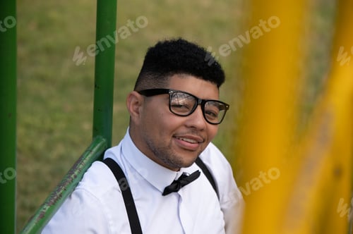 Preview: Portrait of young man shot through jungle gym