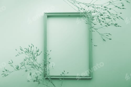 Preview: Dry grass agains with blank picture frame for quote mock-up on a green background
