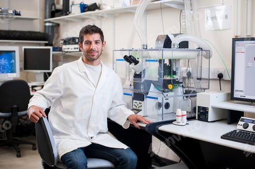 Preview: Scientist smiling in a modern laboratory setting