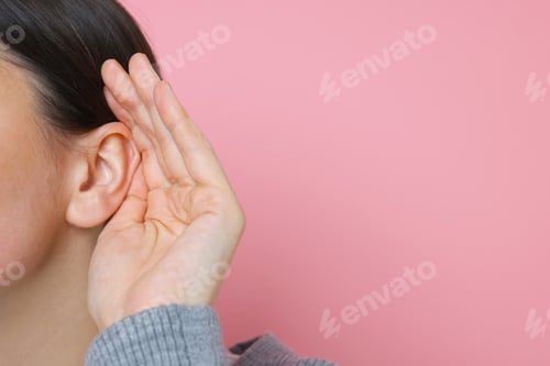 Preview: Woman showing hand to ear gesture on pink background, closeup. Space for text