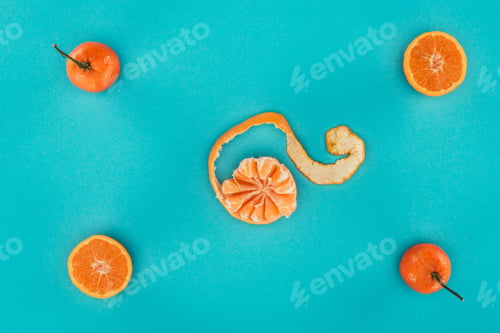 Preview: flat lay with ripe mandarins and orange pieces isolated on blue