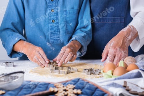 Preview: Grandmother with grandson cooking, kneading dough, baking in the kitchen