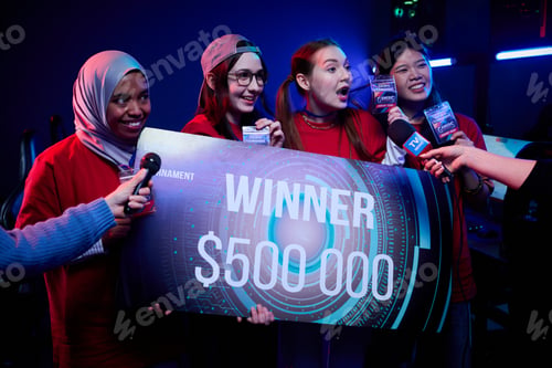 Preview: Diverse Teenage Girls Gamers Team Holding Winner Check after Esports Victory