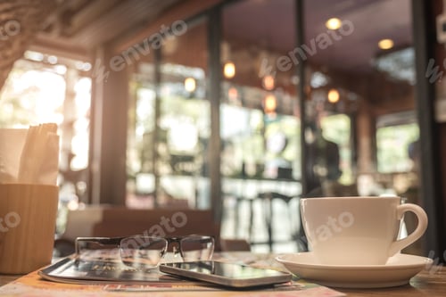 Preview: Coffee mug with cafe blurred background.