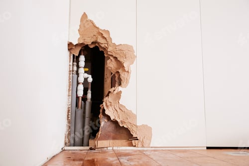 Preview: Damaged wall exposing burst water pipes after flood