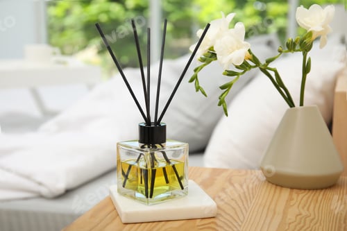 Preview: Reed diffuser and vase with bouquet on wooden nightstand in bedroom