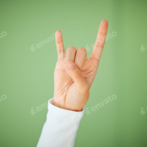 Preview: Shot of an unrecognizable woman showing a rock n roll gesture against a green background