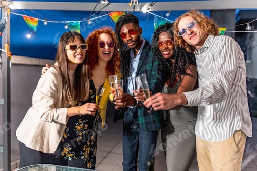 Preview: Friends toasting with champagne in a roof party
