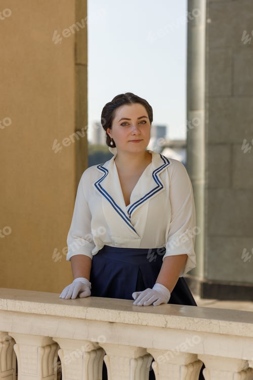 Preview: A girl stands with a suitcase in her hands on the embankment of the river station, port.