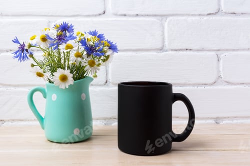 Preview: Black coffee mug mockup with cornflower and daisy in pitcher