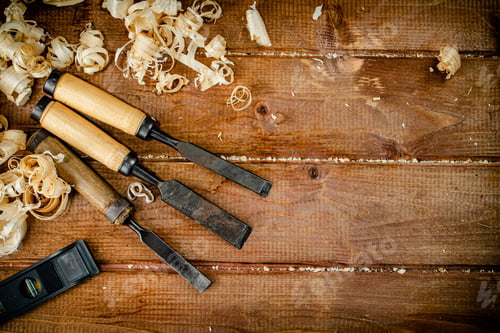 Preview: Chisels with wooden sawdust on the table.