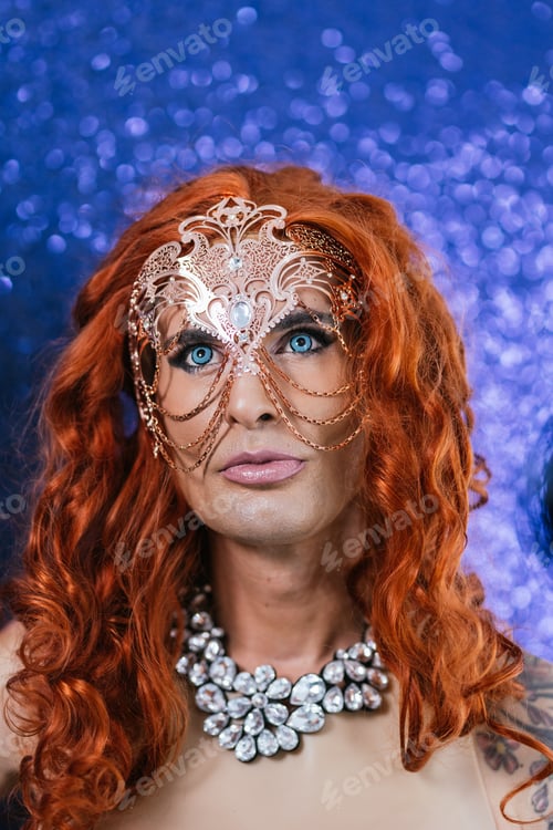Preview: Drag queen wearing a fancy a mask on stage